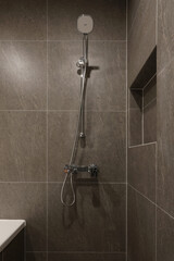 The sepia-tone bathroom has a hotel feel and is equipped with a shower facility