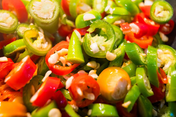 Close-up of colorful chopped chili peppers and garlic, highlighting the textures and colors that make this a perfect ingredient for adding heat and flavor to meals.