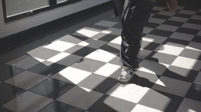 downward shot with view to the ground as a young man walks past the camera, slow motion, c-log canon eos r, full hd