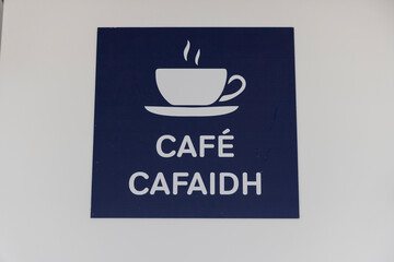 Scotland, Hebrides. Isle of Barra. Cafe sign in Scottish Gaelic and English.