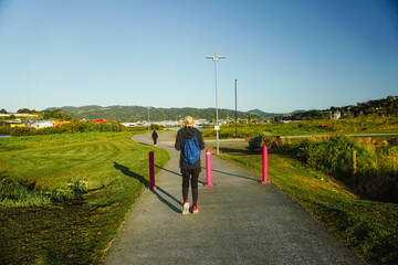 Obraz premium A woman was taking a morning walk nearby Pohe Island Bike Park, Whangarei, New Zealand.