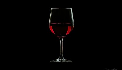 Red Wine Glass, Elegant Beverage, Dark Background, Still Life Photography,  Rich Color, Crystal Stemware,  Relaxing Atmosphere, Evening Drink, Wine Tasting,  Romantic Ambiance.