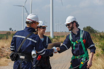 Successful teamwork engineer wind turbine worker safety uniform survey operational planning...