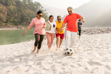 45-55 yeas, 60-70 years, active seniors, adult, adventure, barefoot, beach, carefree, casual clothing, cheerful, day, enjoyment, excitement, football, friendship, getting away from it all, group of pe