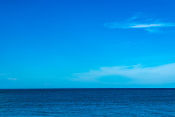 Nature of the beach and sea Summer with sunshine, sandy beaches, clear blue waters sparkling against the blue sky. On an island with good ecology and environment Background for summer vacation