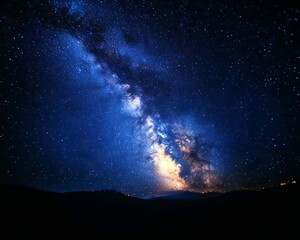 Majestic Milky Way galaxy over dark mountain range at night.