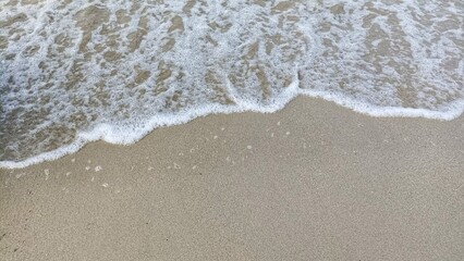 the beauty of the beach with few waves and white sand
