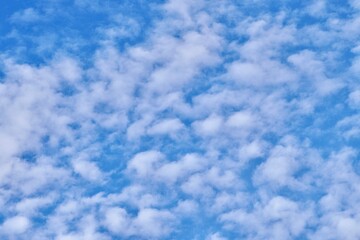 Calming blue sky with white clouds isolated on horizontal outdoor environment background.