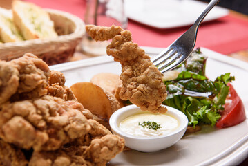 Trying to dip fried chicken in sauce