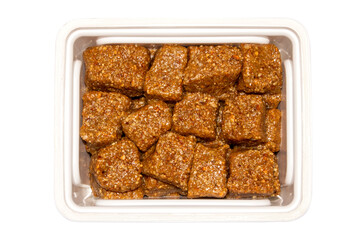 Kozinaki with honey.Nuts and seeds with honey.Kozinaki made of seeds and nuts on a white background.