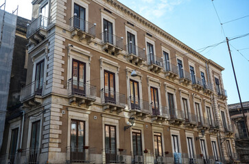 Characteristic Italian facades of tenement houses with balconies in Catania