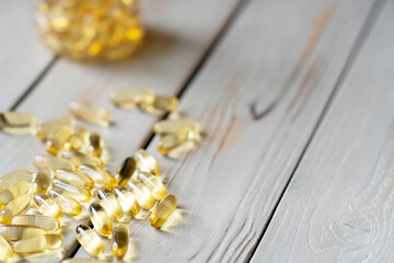 vitamin D capsuleson wooden background.