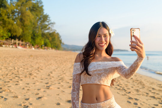 Woman taking selfie at beach