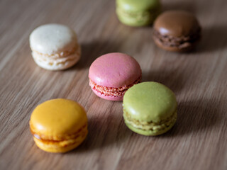 Tasty colorful macaroons on the table. Excess weight and diet. Calorie counting. Harmfulness of sugar to health. Different types of macaroons