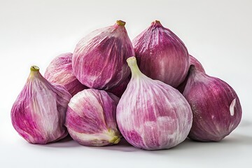 A pile of figs with their skins peeled back revealing the vibrant fruit
