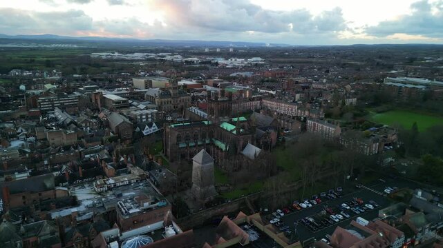 Historic Chester Cathedral anti-clockwise pan by drone in winter golden hour, UK