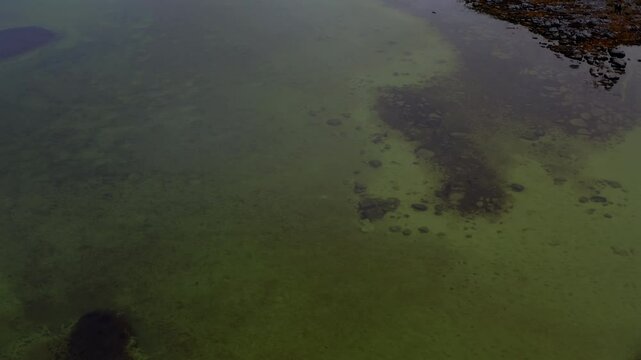 Drone flying over a seasonal lake (turlough) revealing the Burren groundwater network. County Clare.