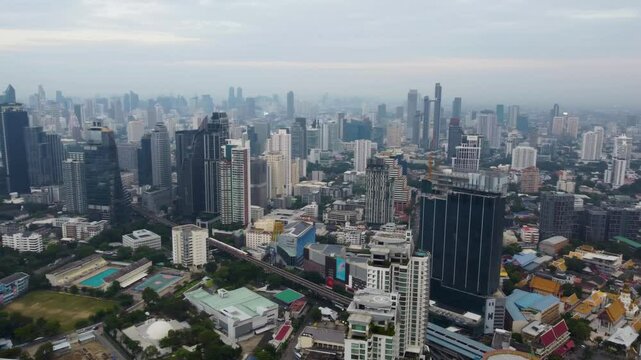 panning drone aerial over bangkok thonglor and sukhumvit bts train