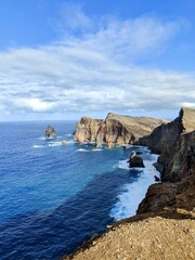 A breathtaking view from the cliffs of Ponta Sao Lorenco. It shows the beautiful contrast between the deep blue ocean and dry brown coastline.