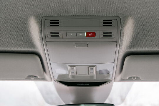 Overhead view of a car's interior console with lighting and SOS button