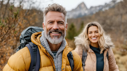 Fototapeta premium Older man and woman hiking in forest, enjoying nature beauty together