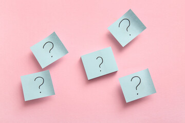 Sticky notes with question marks on pink background
