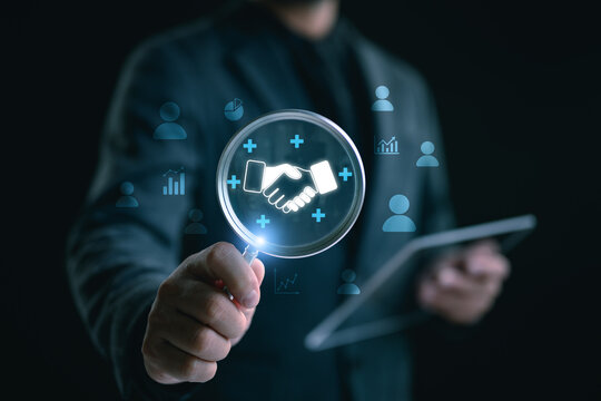 Trusted partner. Trustworthy collaboration, company or contract. Confidence to work together. Businessman use Magnifying glass finding shake hand icon. Build trust in business finance relationships.