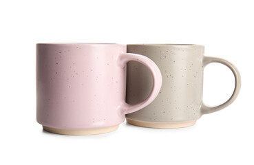 Stylish ceramic mugs isolated on white background