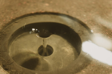 Close-up of Water Flowing into a Drain