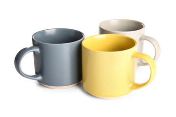 Different ceramic mugs isolated on white background
