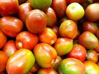 Many tomatoes red green vegetable in frame. Background concept. 