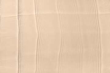 Texture of clean water with ripples on beige background