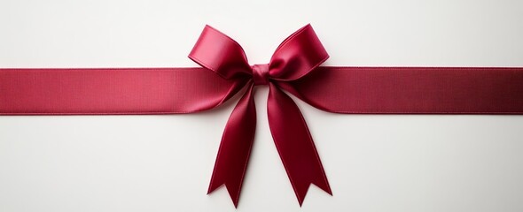 Elegant maroon ribbon bow on white background.