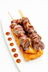 beef skewer on the white