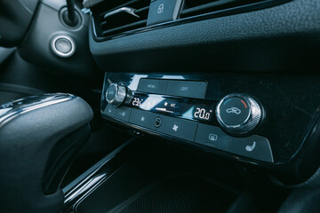 Modern car interior detail: climate control panel and gear stick