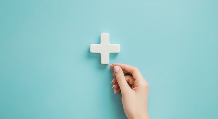 Obraz premium Hand adding white plus sign on blue background.