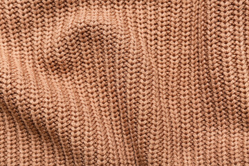 Texture of warm knitted fabric as background, closeup