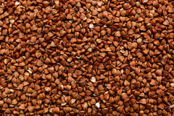 Texture of buckwheat grains as background, closeup