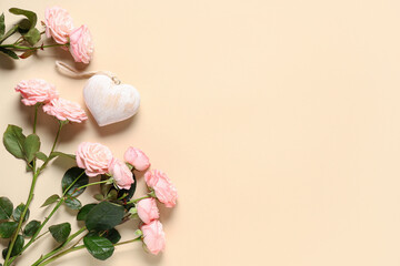 Composition with rose flowers and heart-shaped toy on beige background. Valentine's Day celebration