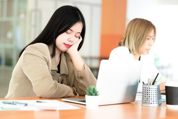 Businesswoman is sleeping on her desk at work during work hours