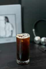 A cup of iced Americano on the table at the cafe