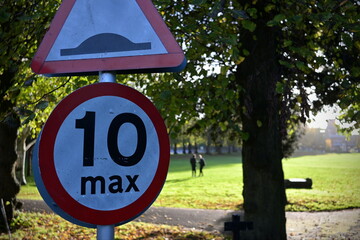 View a generic road hump and 10 mph max speed limit road signs on a country lane