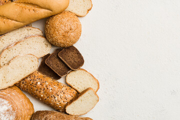 Homemade natural breads. Different kinds of fresh bread as background, top view with copy space