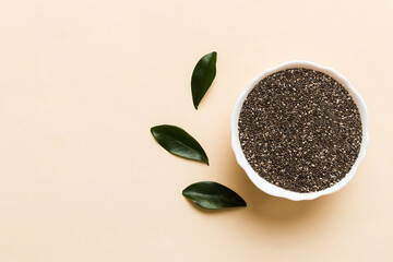 Chia seeds in bowl on colored background. Healthy Salvia hispanica in small bowl. Healthy superfood