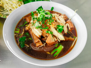 The steaming bowl of noodles sits invitingly on the table, filling the air with a savory aroma.