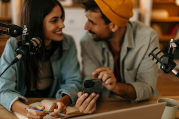 Bright and airy podcast studio with male and female co-hosts deep in discussion