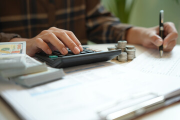 Saving money. Businessman Accountant verify growing business and saving money stacking coins with calculator. Accountancy Concept