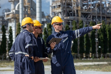 Engineer working using tablet together at station refining oil petrochemical. Technician worker...