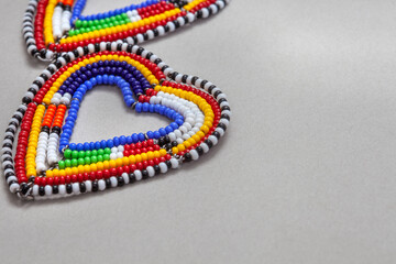 A pair of colorful beads that form a heart shape