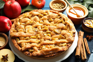 Homemade apple pie and ingredients on blue wooden table